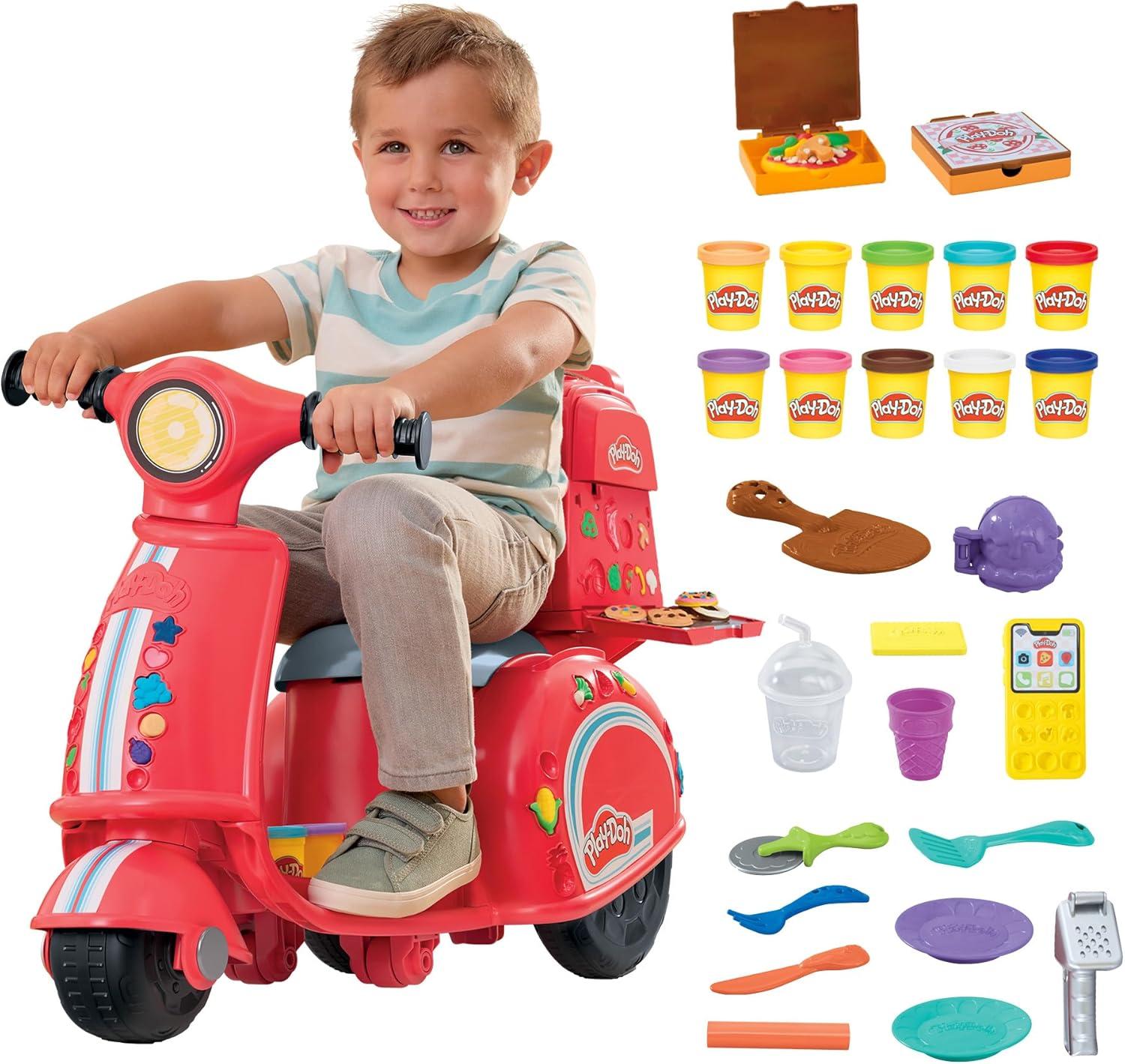 A colorful Play-Doh pizza delivery scooter playset in red and yellow, with a pizza box slot on the side, a checkout station, and Play-Doh cans and tools arranged around it